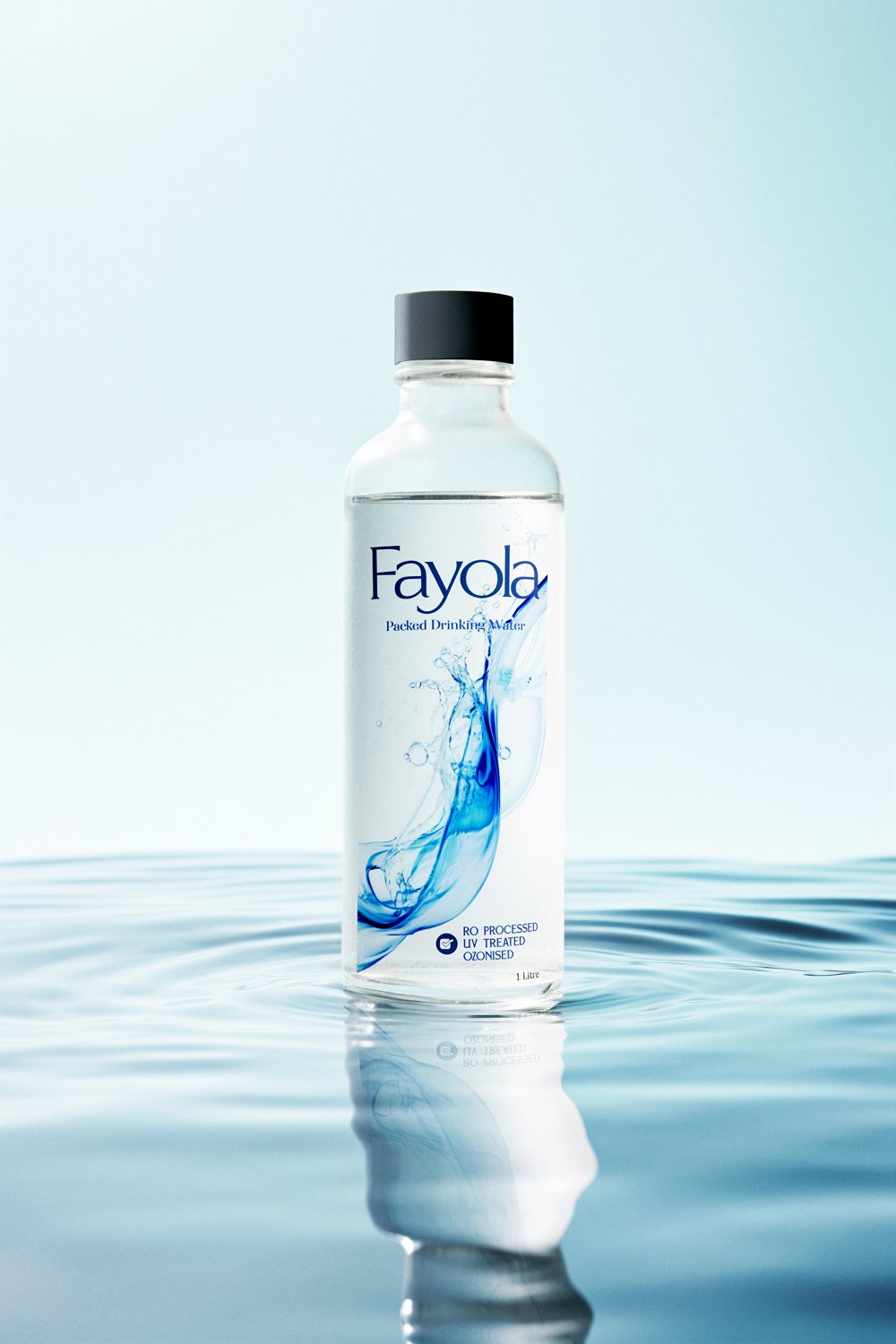 Fayola premium packaged drinking water bottle featuring minimalist label design, blue water splash graphics, transparent PET bottle, and commercial product mockup on reflective water.